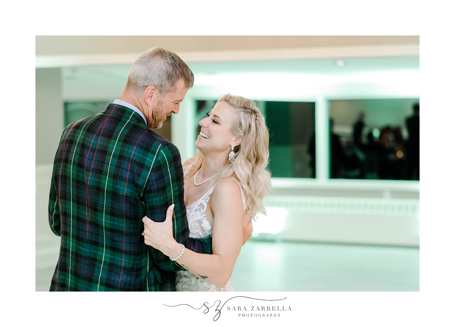 bride smiles at groom in plaid jacket dancing during Sutton MA wedding reception