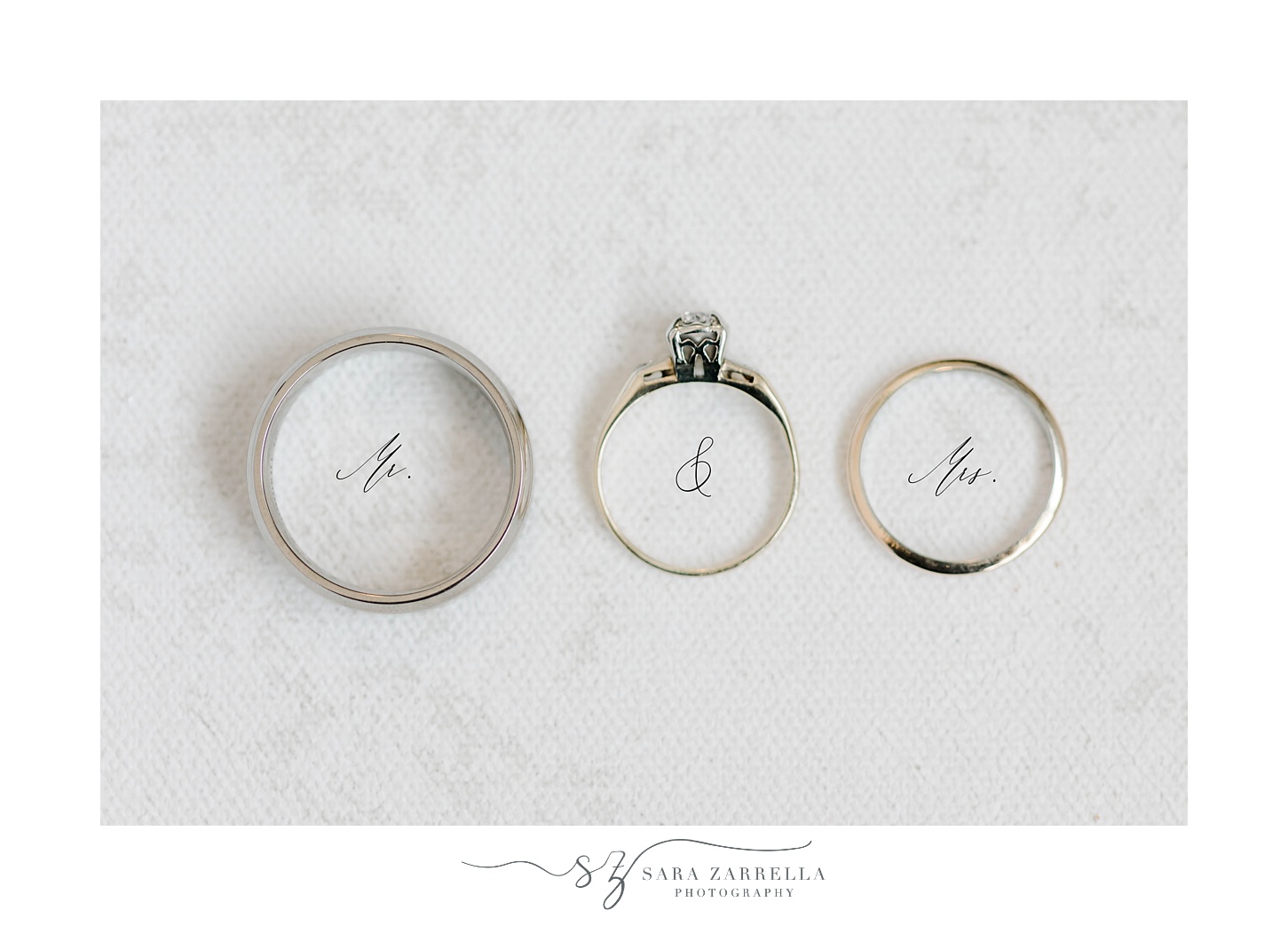 wedding rings rest on Mr and Mrs calligraphy 