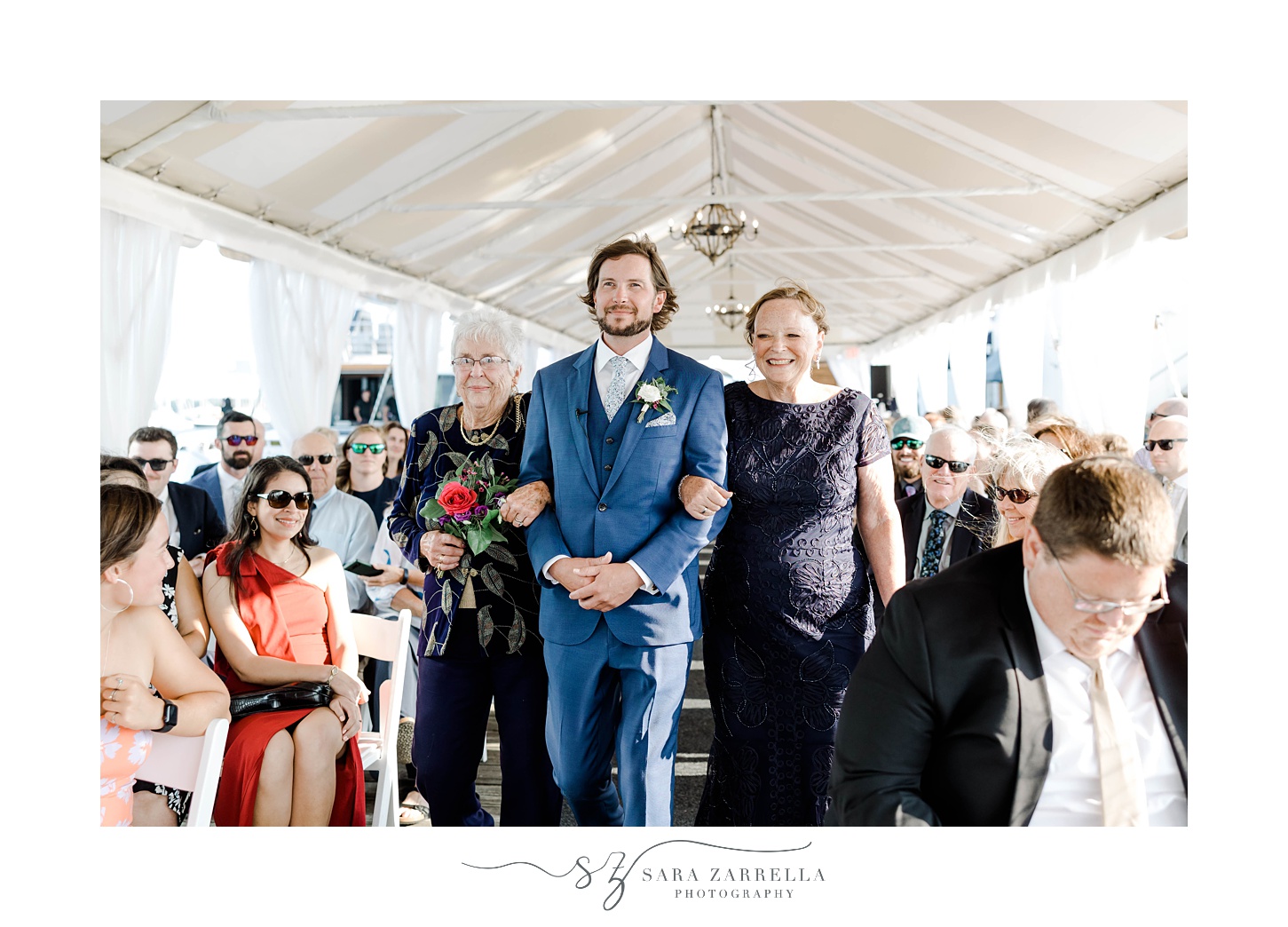 groom walks mother down aisle for wedding ceremony at Regatta Place