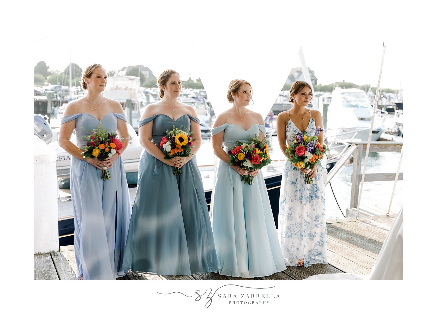 bridesmaids in mismatched blue gowns stand during arbor at Regatta Place
