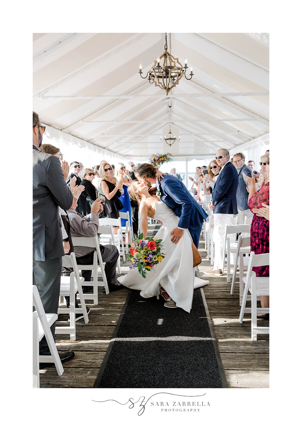 newlyweds kiss in aisle after ceremony at Regatta Place