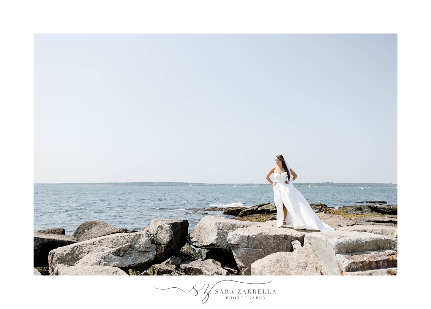 bride stands on rocks at Regatta Place in Newport RI