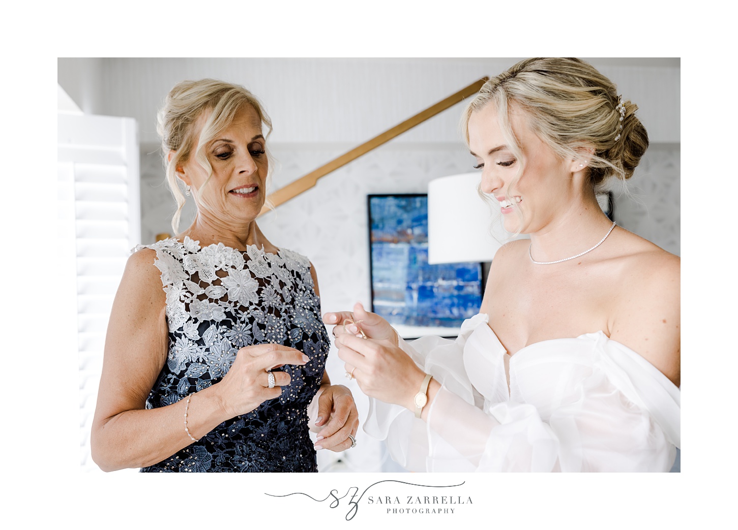 mother helps bride with jewelry before Newport RI wedding 