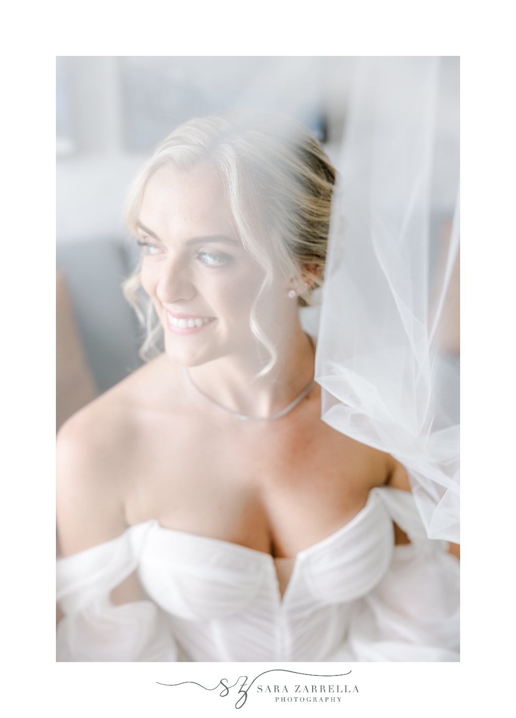 bride smiles under veil in off-the-shoulder wedding gown at Newport Harbor Island Resort