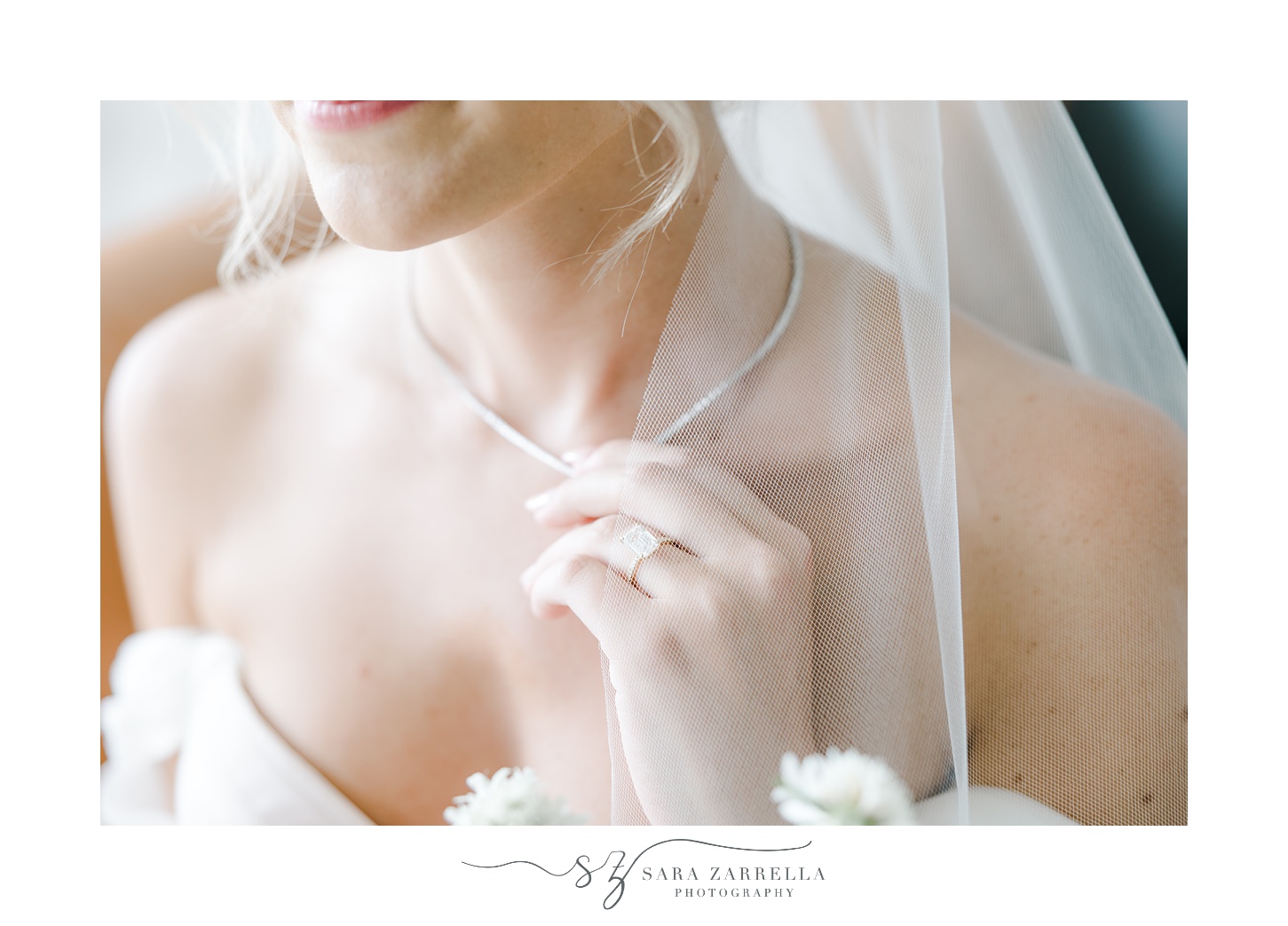 bride adjusts necklace while sitting on sofa at Newport Harbor Island Resort