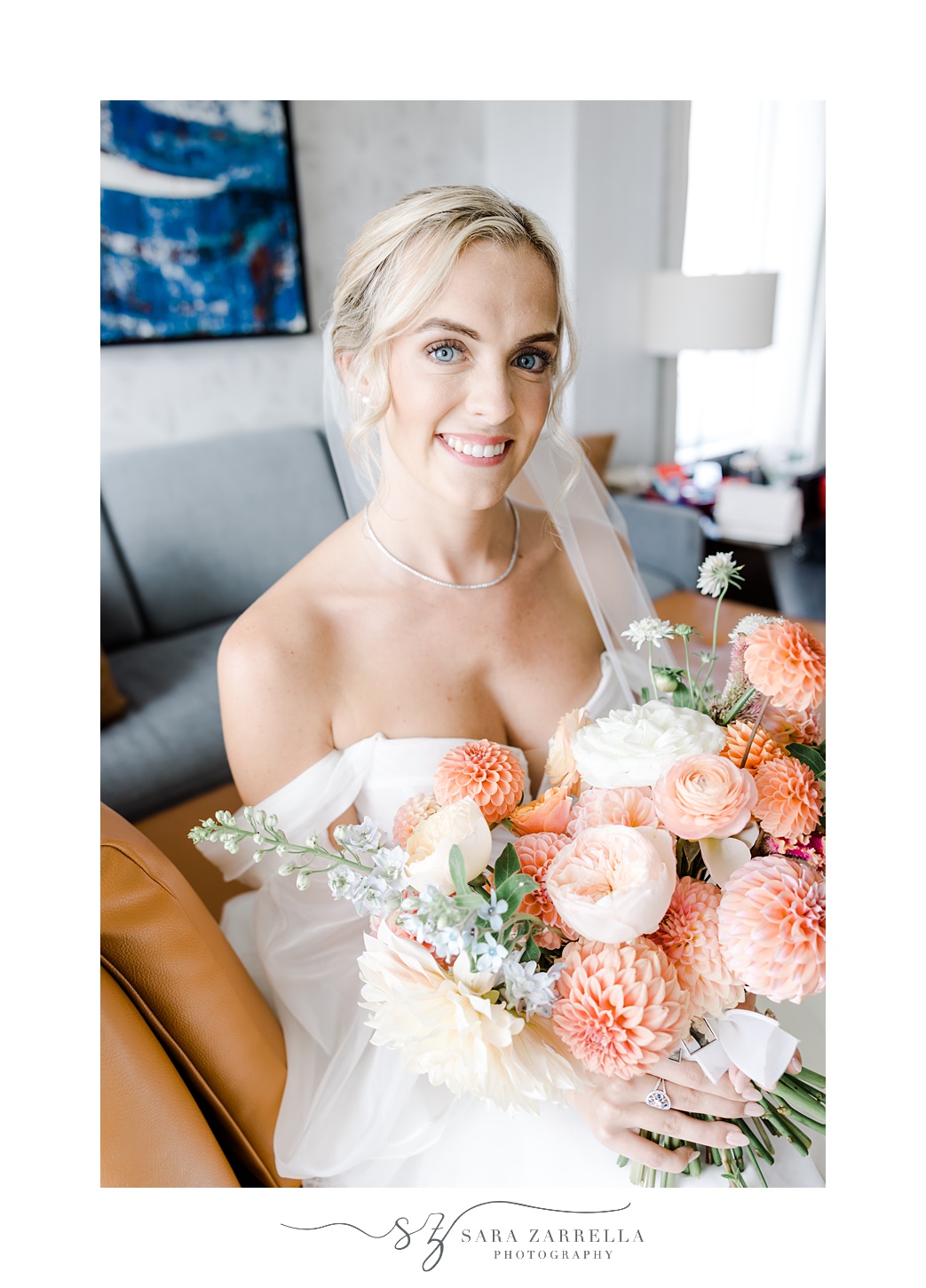 bride holds bouquet of peach and pink flowers for autumn wedding day