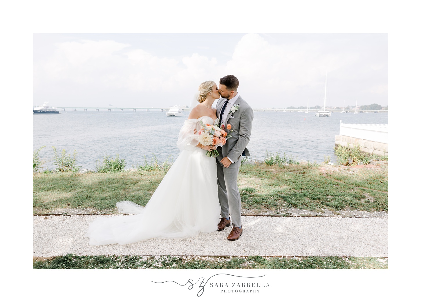 bride and groom kiss on sidewalk by Newport Lighthouse at Newport Harbor Island Resort