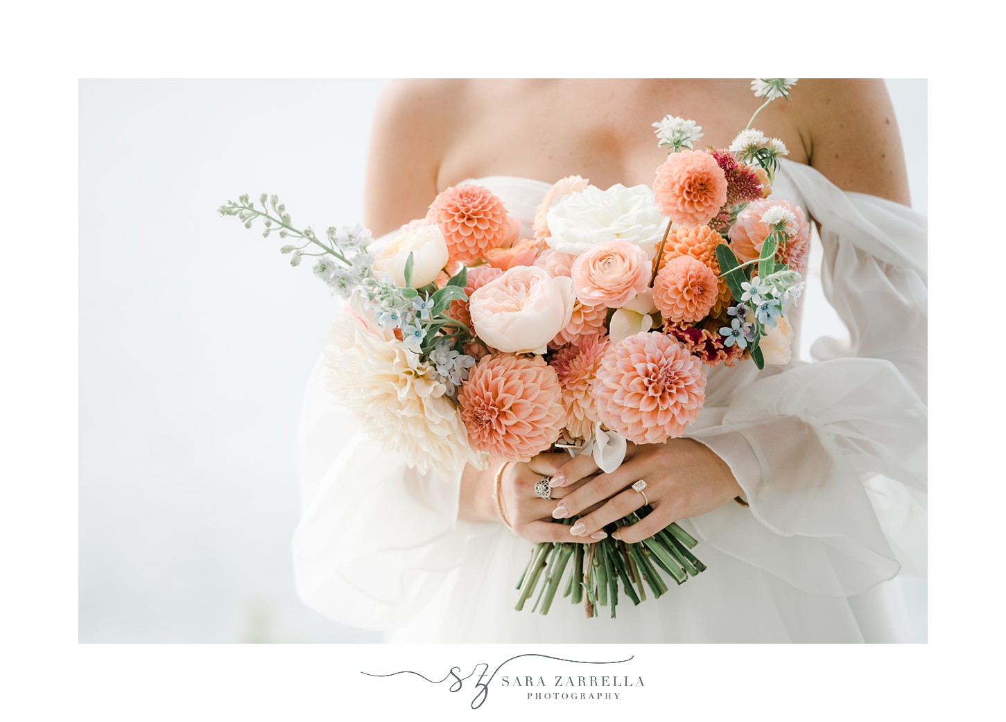 bride holds bouquet of pink and peach flowers 