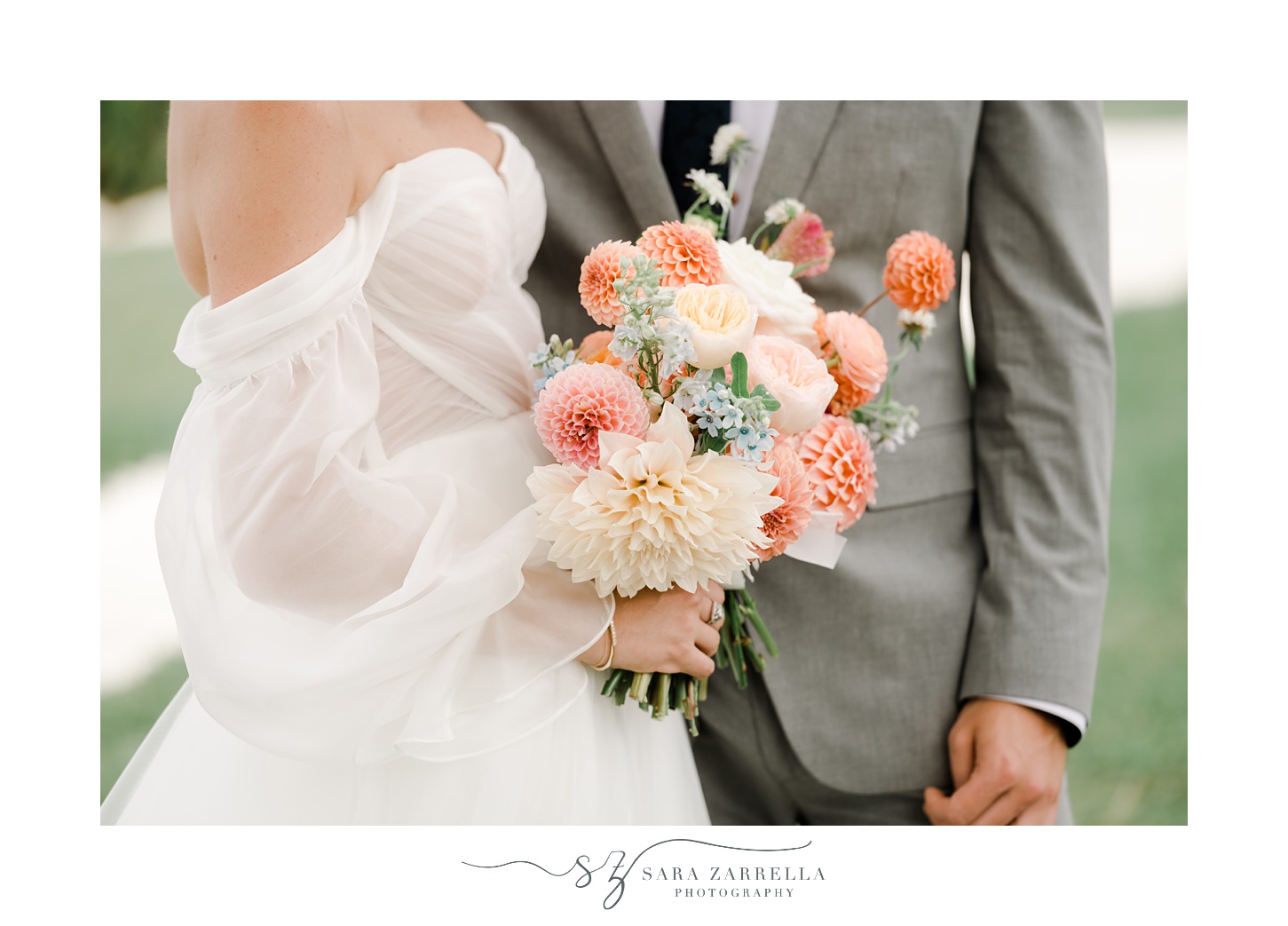 bride and groom hold bouquet of pink and peach flowers in Newport RI