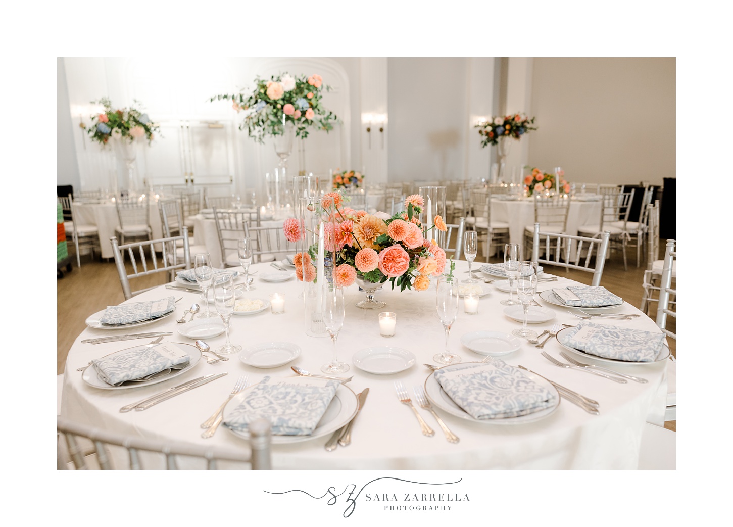 wedding reception tables with bright pink and peach floral centerpieces at Newport Harbor Island Resort