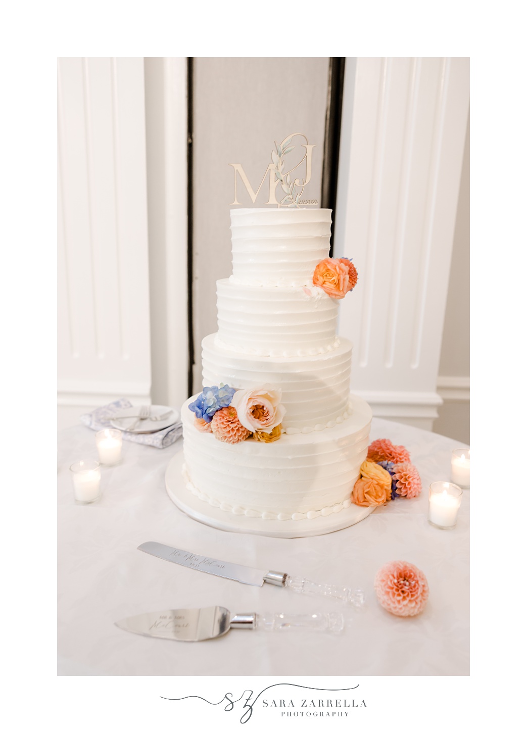 tiered wedding cake with peach and blue flowers 