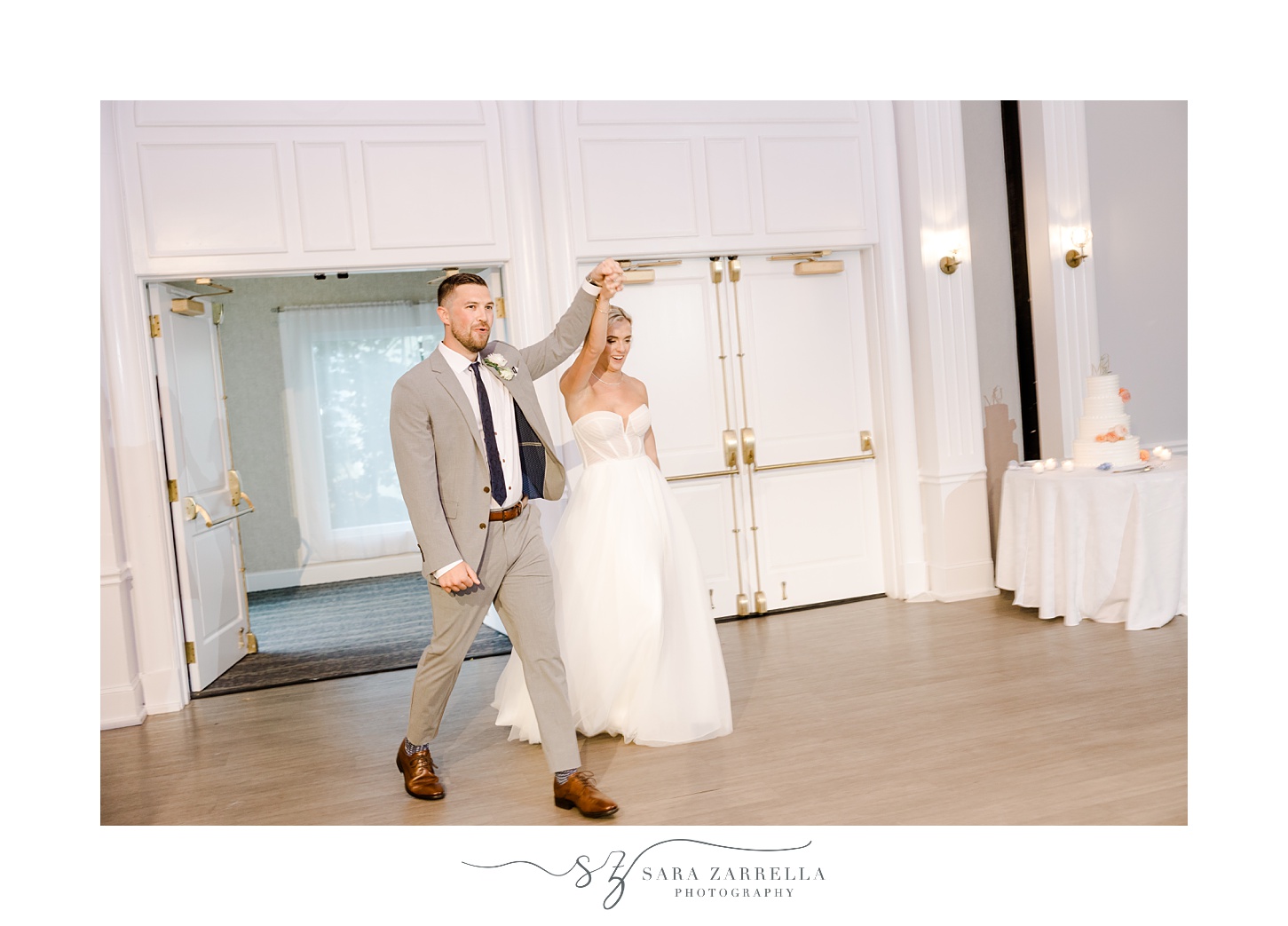 bride and groom cheer walking into reception at Newport Harbor Island Resort