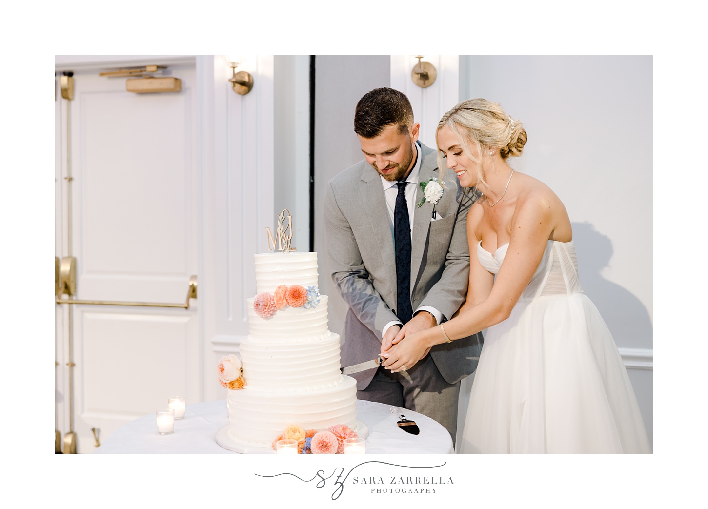 bride and groom cut tiered wedding cake during wedding reception at Newport Harbor Island Resort