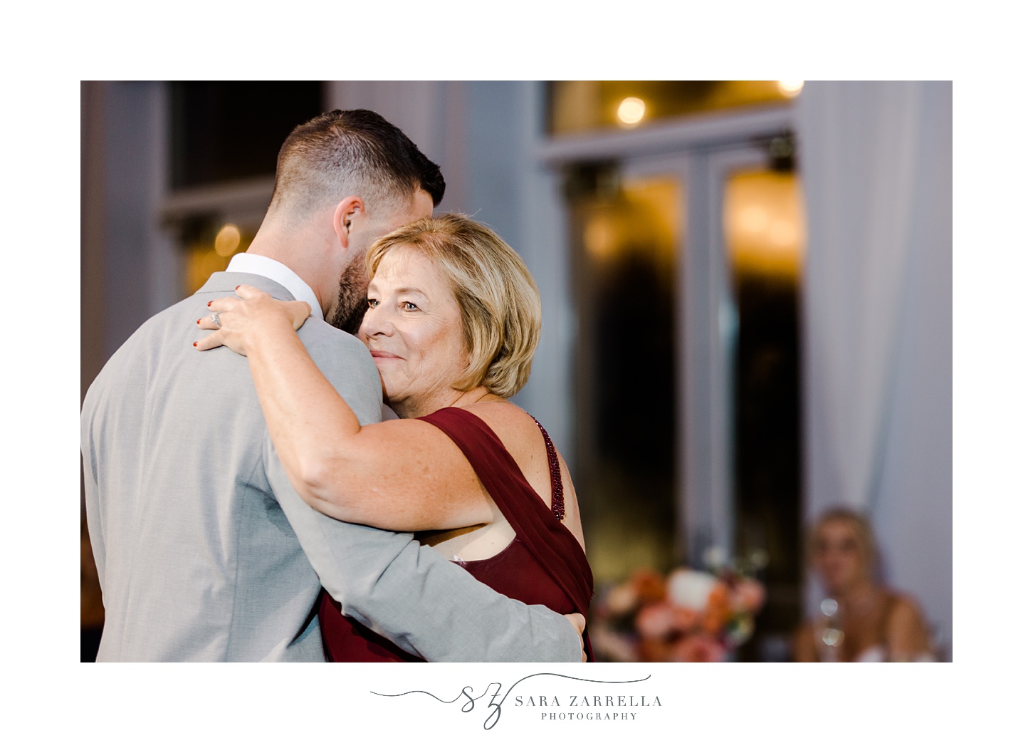 mother hugs son during during Newport RI wedding reception 