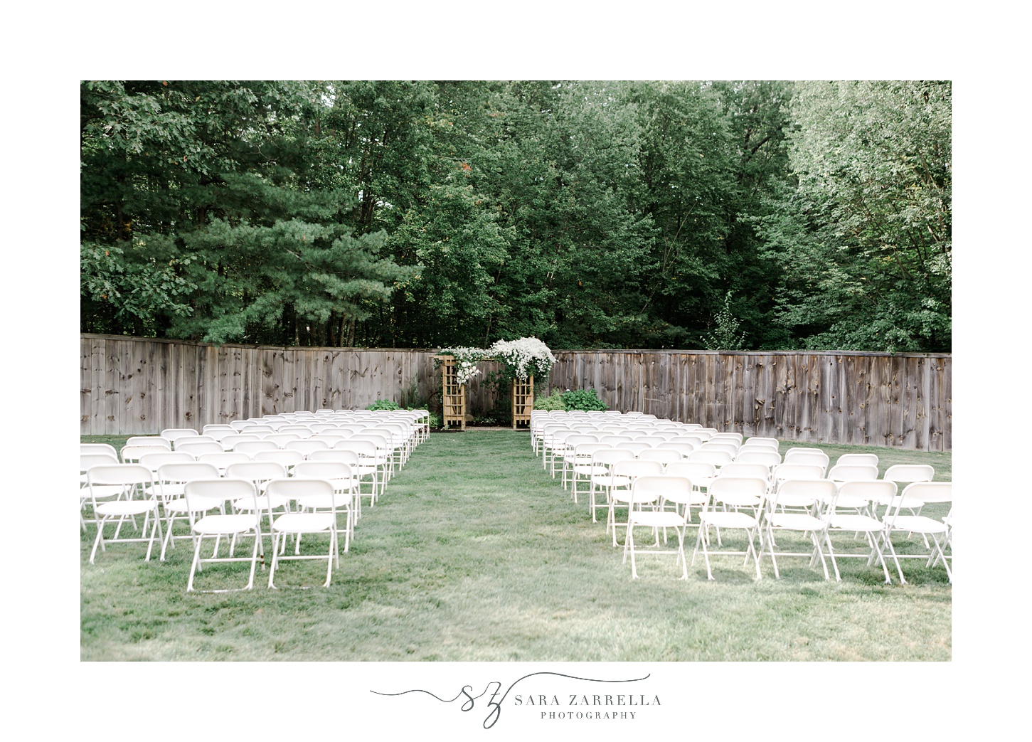 Blissful Meadows wedding ceremony site with white chairs and white arbor 