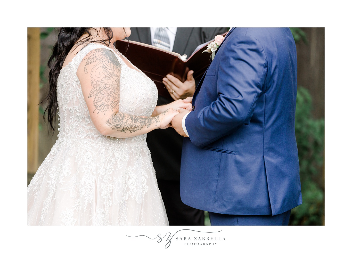 newlyweds hold hands during Blissful Meadows wedding ceremony