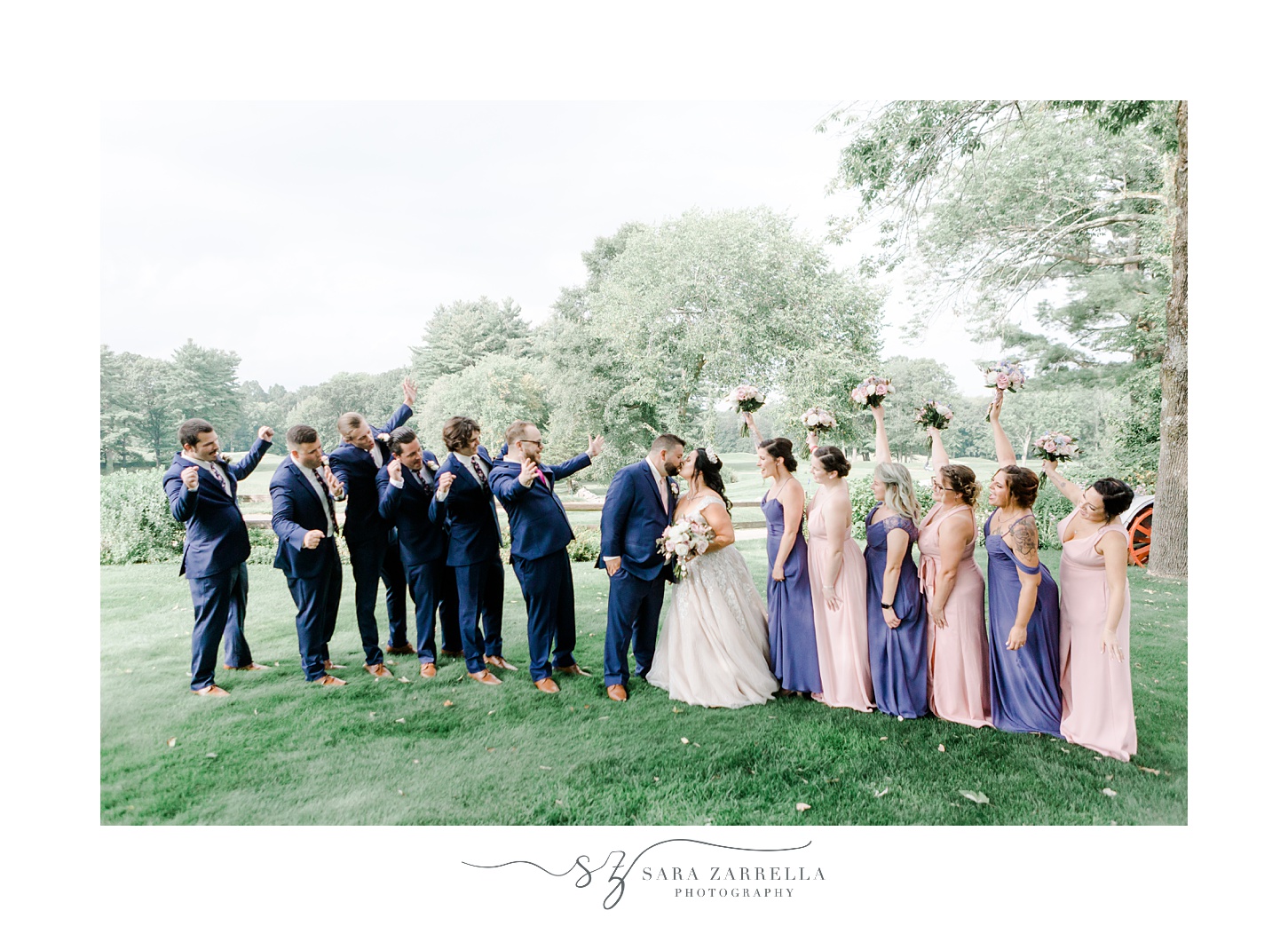 newlyweds cheer during portraits on lawn at Blissful Meadows