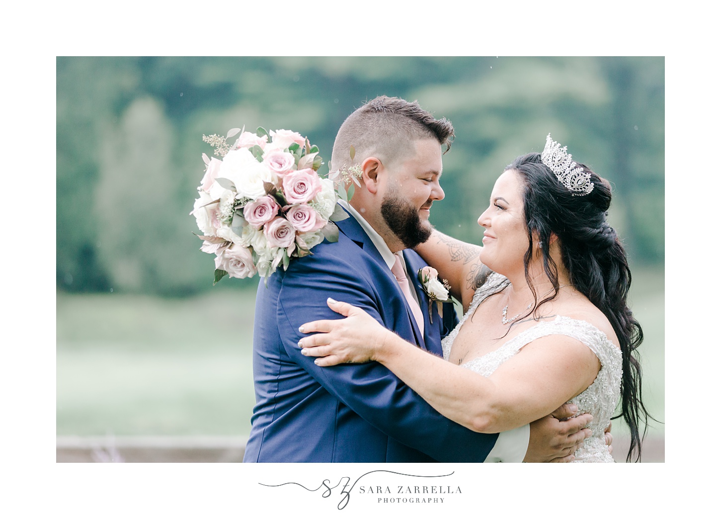 bride and groom hug with bride's bouquet on his neck