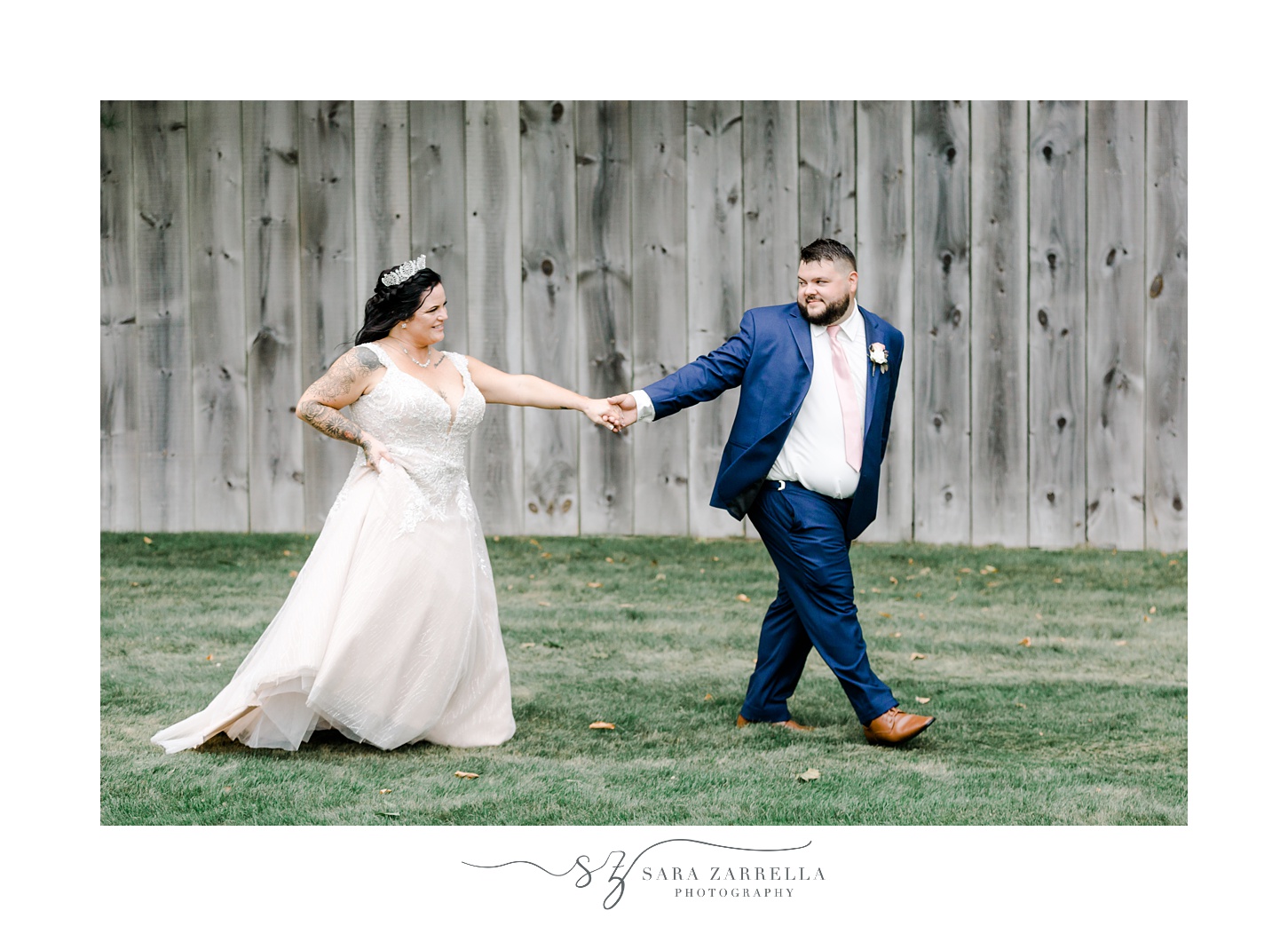 groom and bride holds hands walking by wooden barn at Blissful Meadows