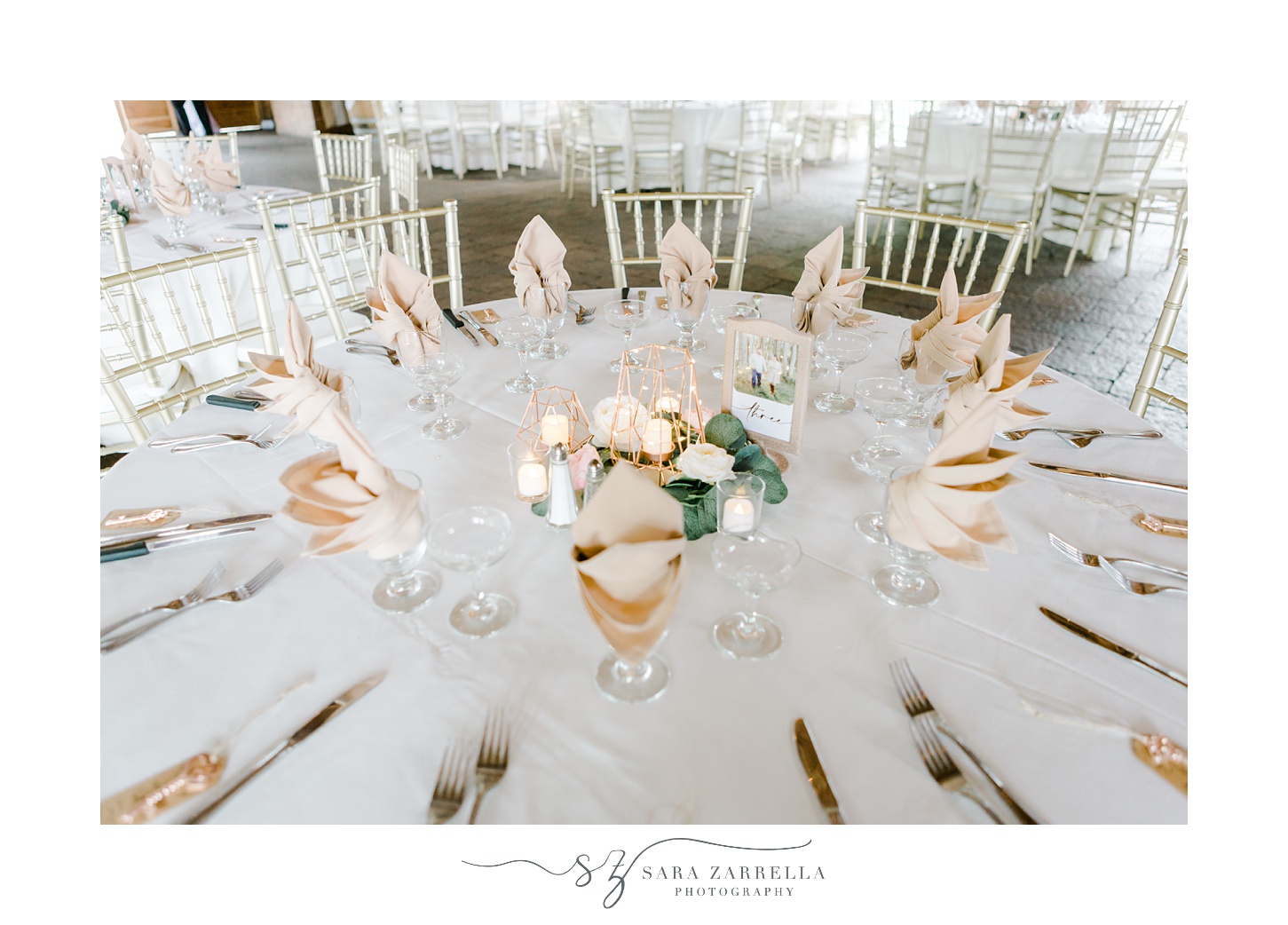 wedding reception in the Pavilion at Blissful Meadows with gold place settings 