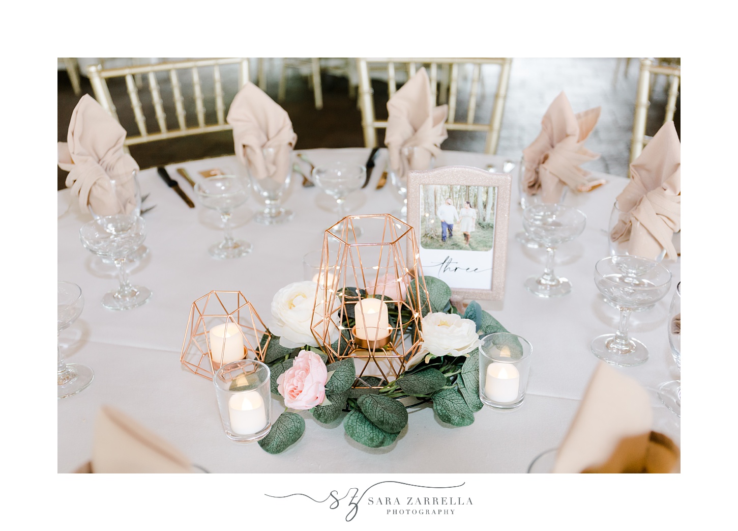 wedding reception in the Pavilion at Blissful Meadows with pink and white flowers and gold candle holders 