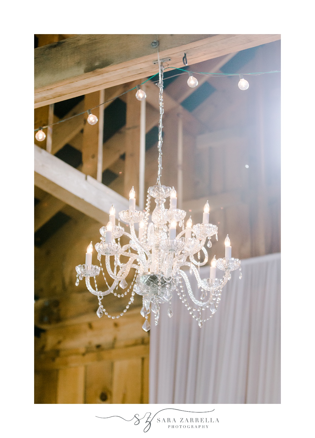 chandelier hangs from roof for wedding reception in the Pavilion at Blissful Meadows
