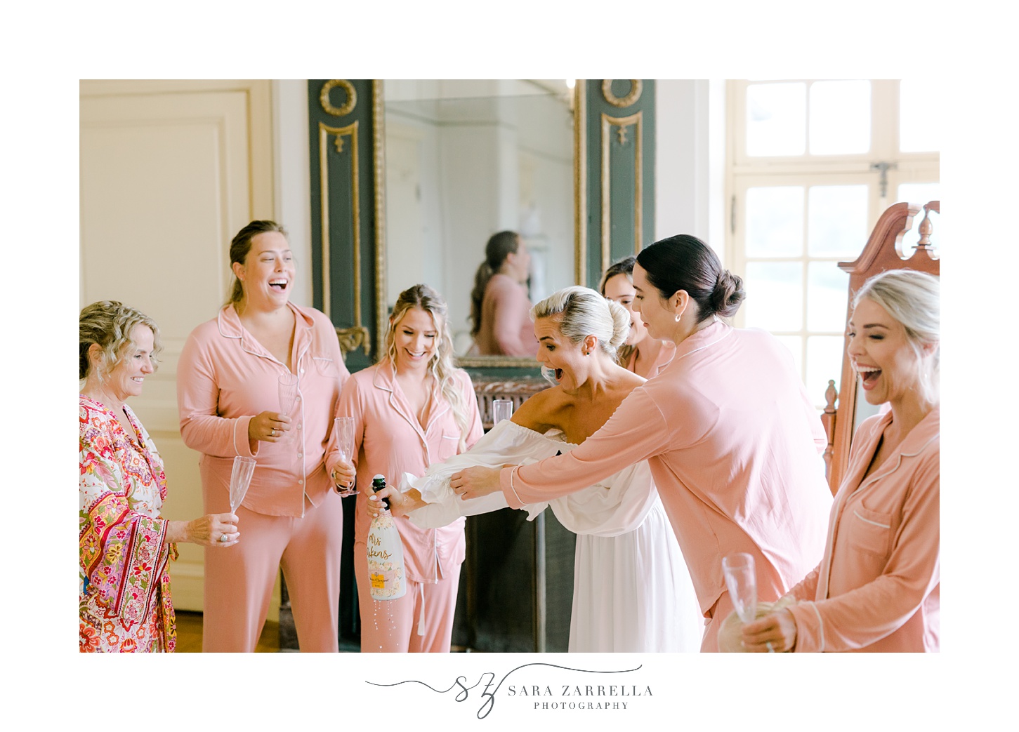 bridesmaids help bride pop champagne in suite at Glen Manor House