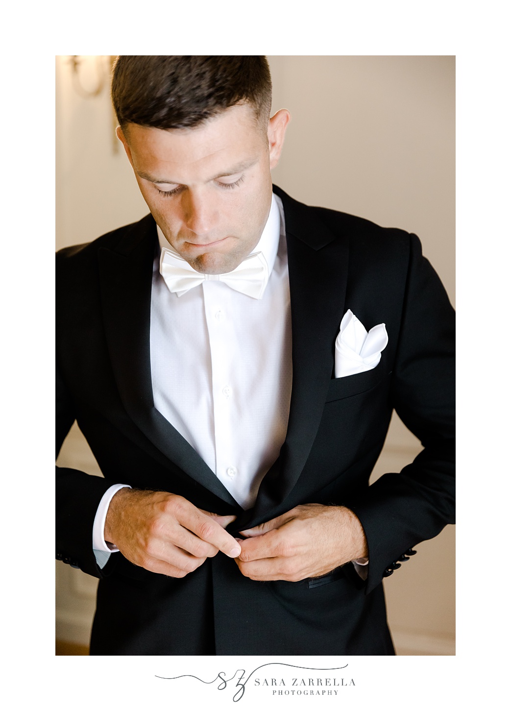 groom adjusts suit jacket at Glen Manor House