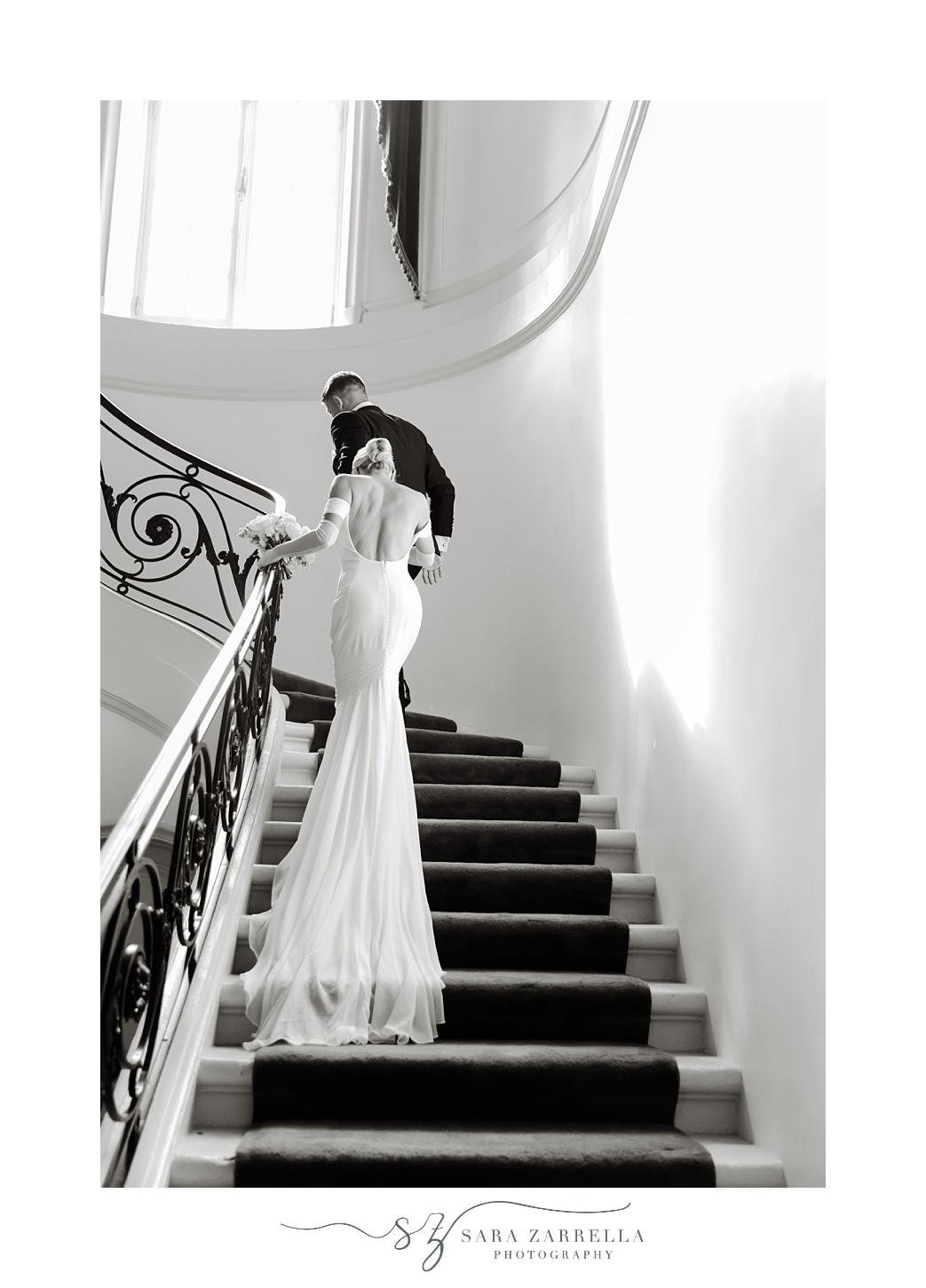 bride walks up steps behind groom inside Glen Manor House