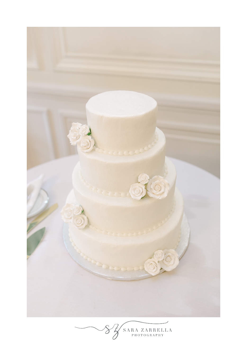 tiered wedding cake with ivory flowers 