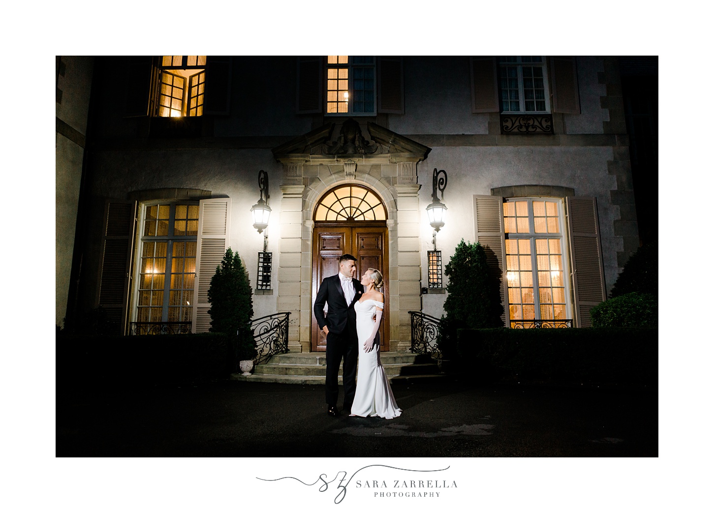 newlyweds hug outside Glen Manor House at night