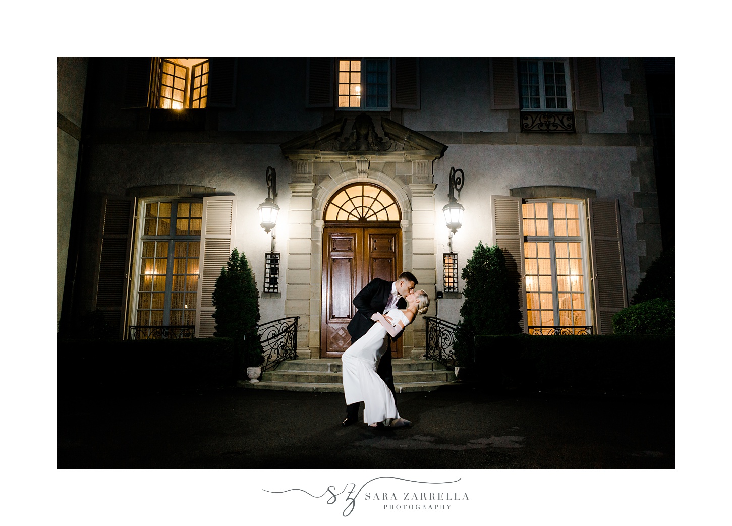 newlyweds hug outside Glen Manor House at night