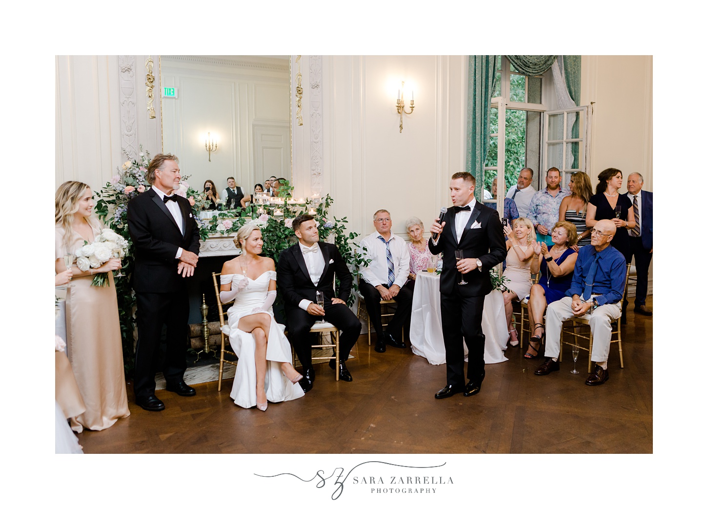 bride and groom listen to toasts during Rhode Island wedding reception