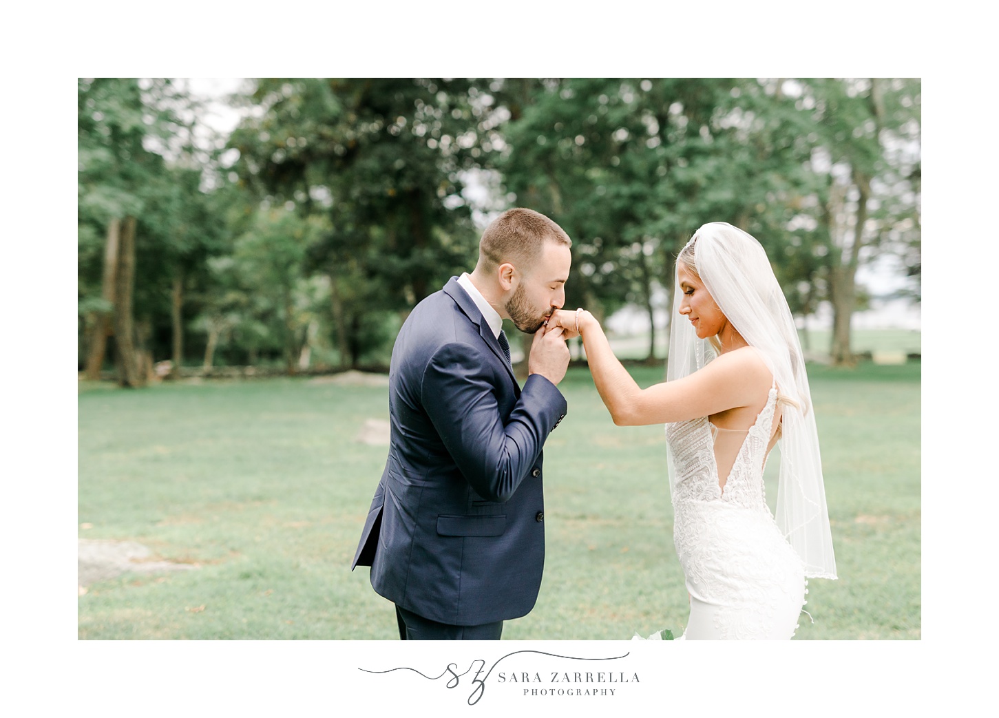 groom lifts up bride's hand kissing it during portraits at Colt State Park