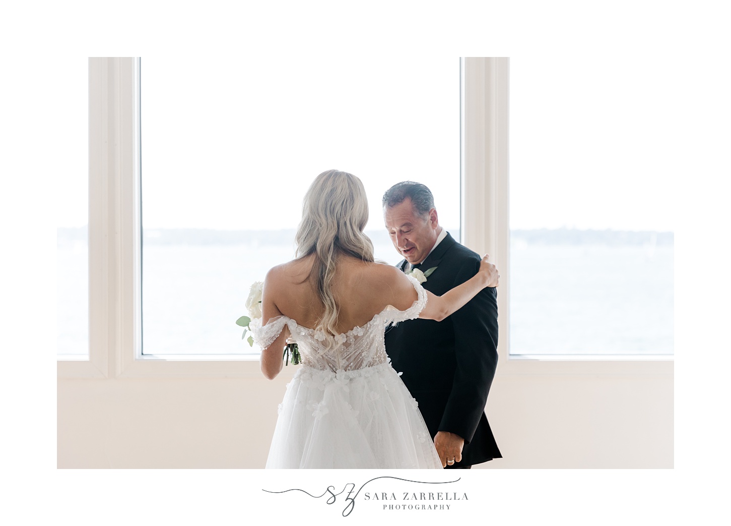 father looks at bride during first look at Belle Mer Island House