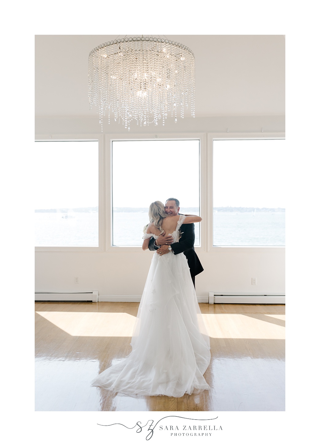 bride and father hug during first look at Belle Mer Island House