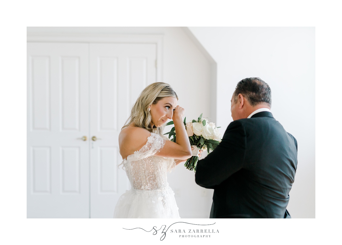 bride cries during first look with father inside suite at Belle Mer Island House