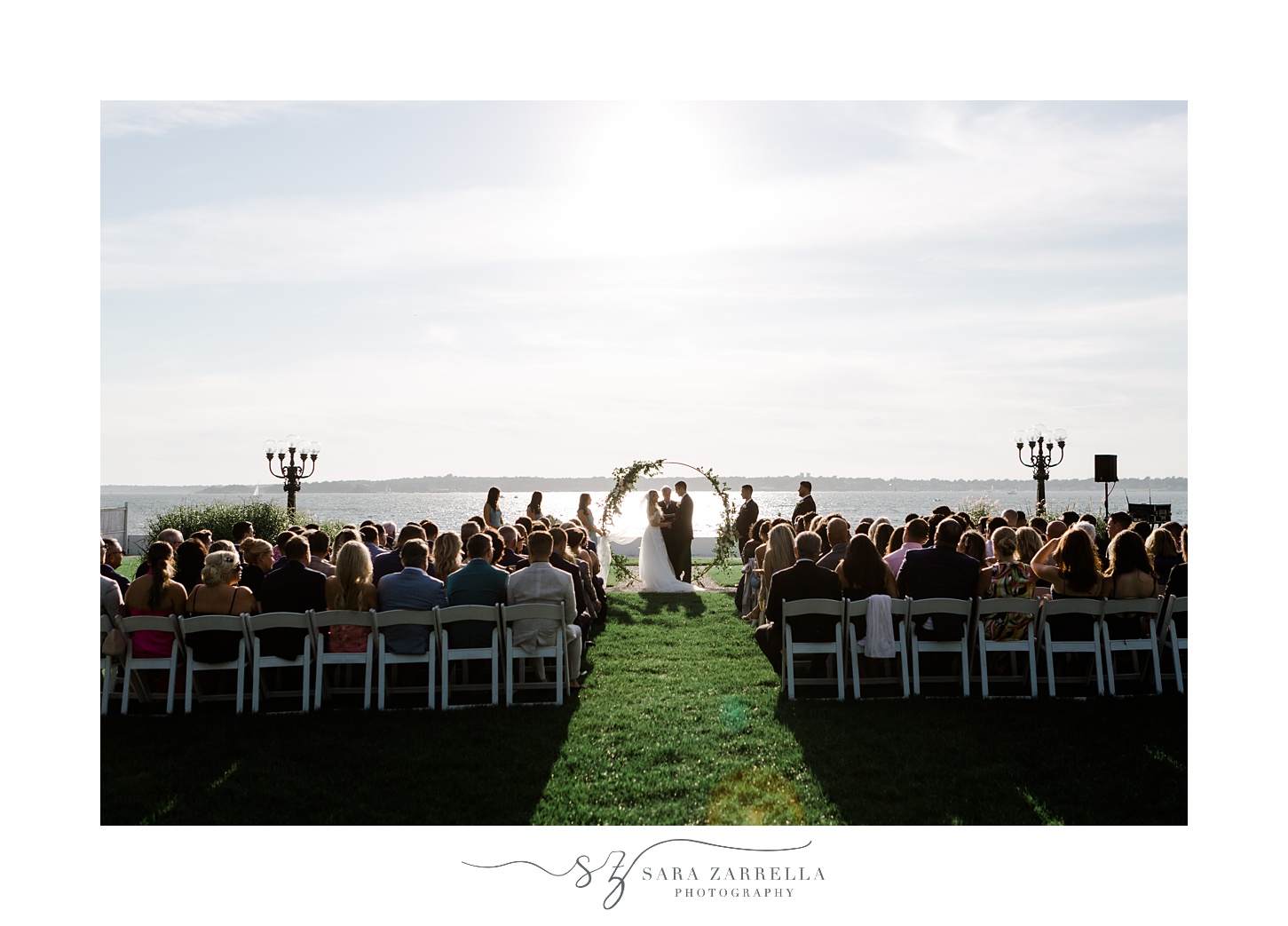 waterfront wedding ceremony on lawn at Belle Mer Island House