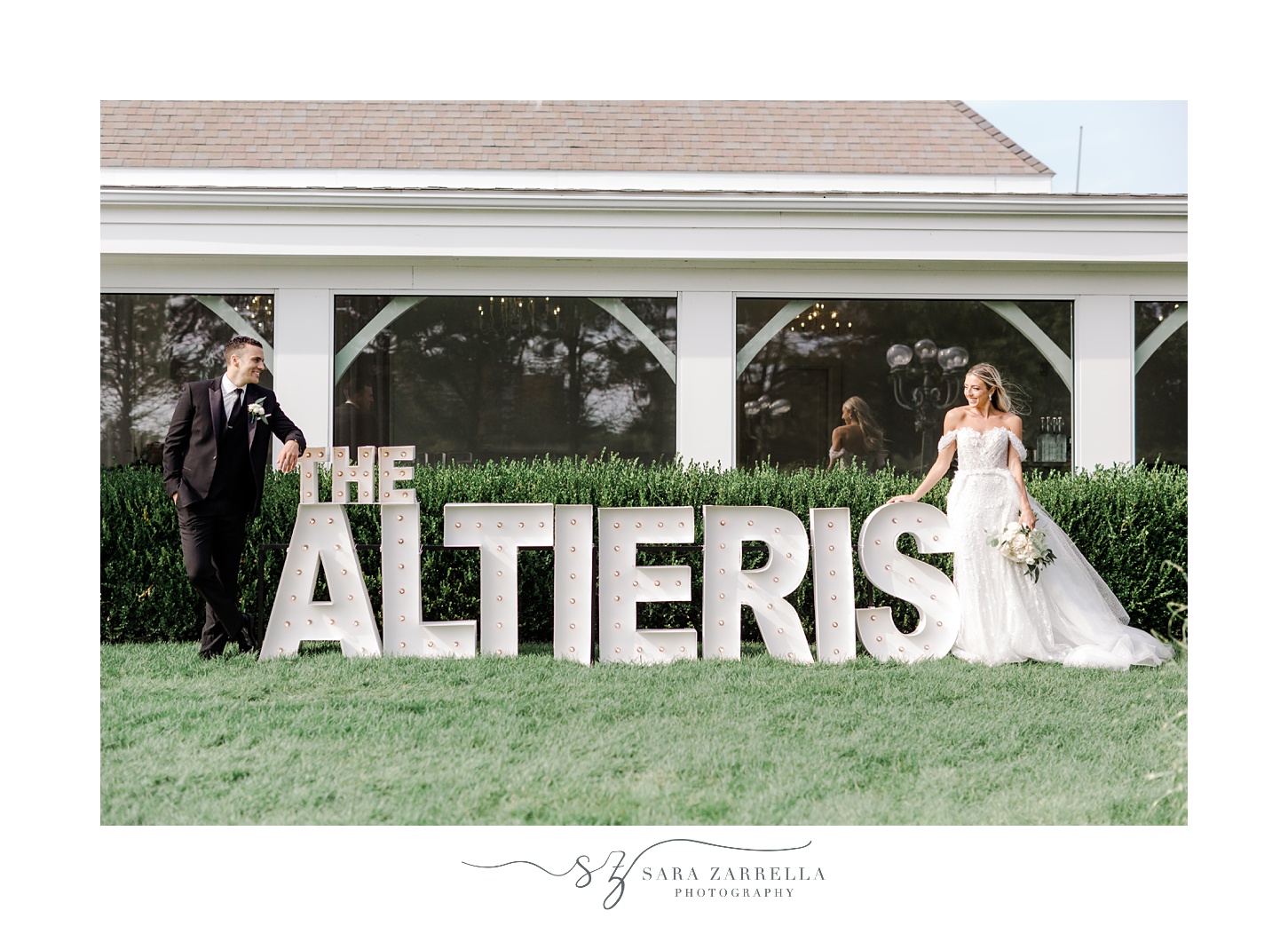 bride and groom pose outside custom marquee of last name at Belle Mer Island House