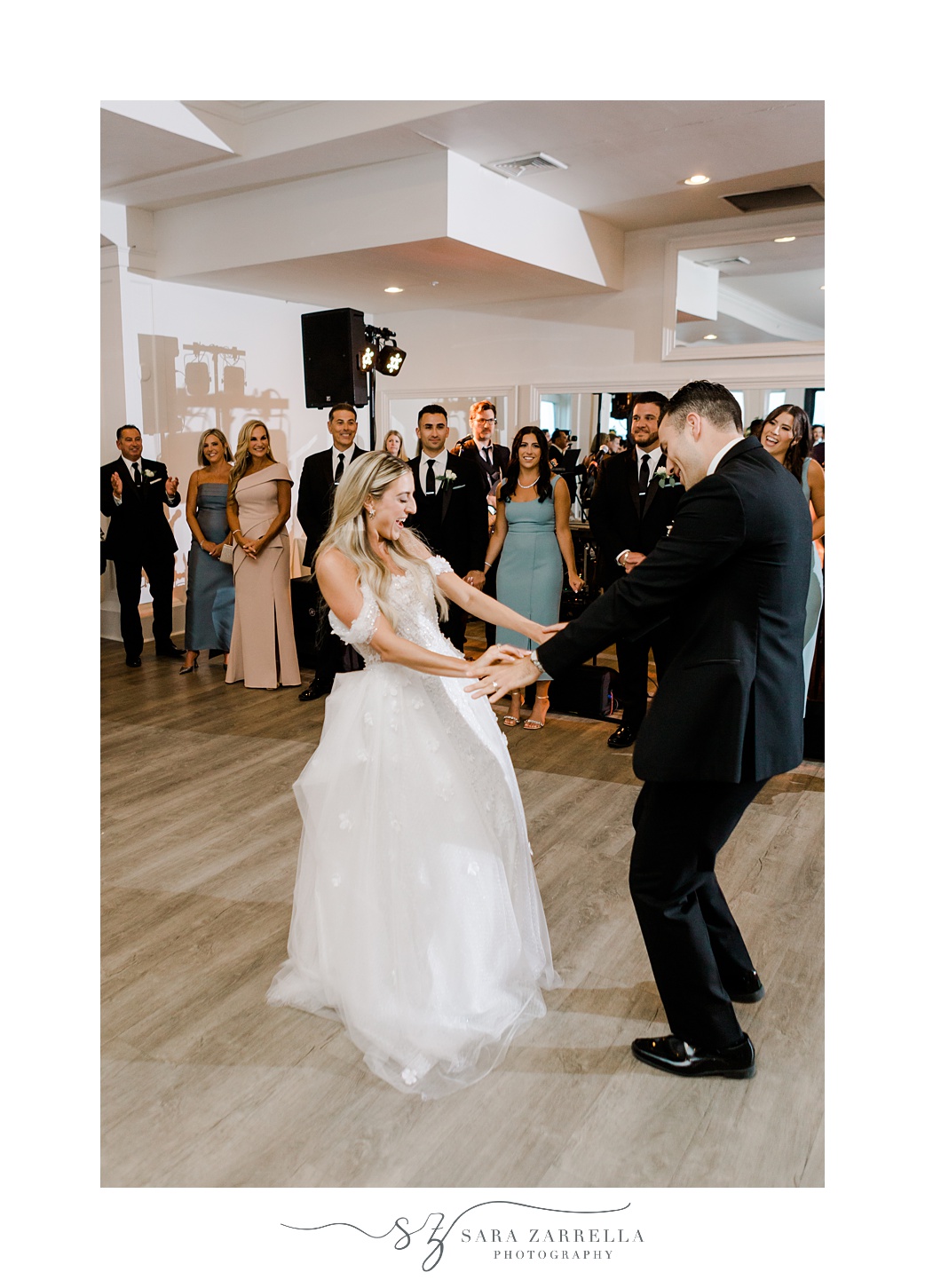 bride and groom hold hands dancing at Belle Mer Island House