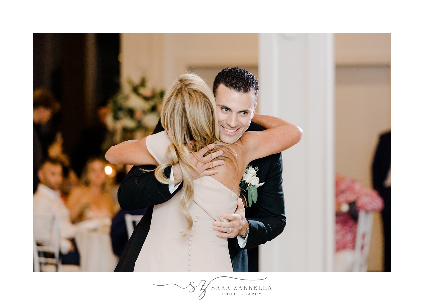 groom hugs mother smiling during Newport RI wedding reception 