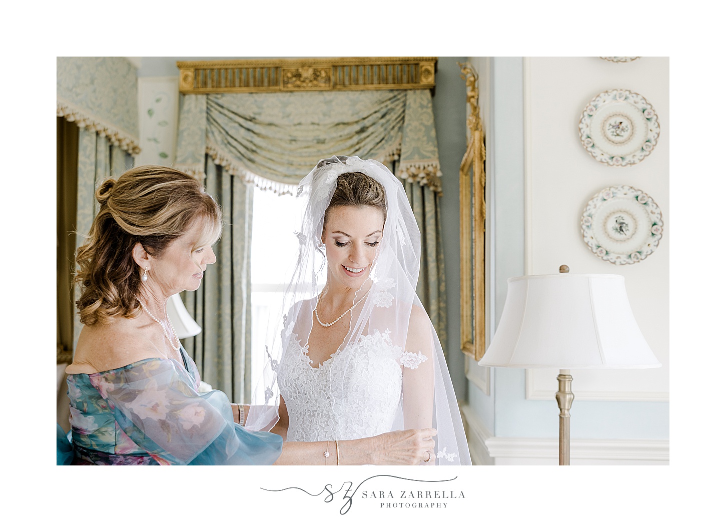 mother adjusts veil around bride's shoulders inside the bridal suite at the Chanler