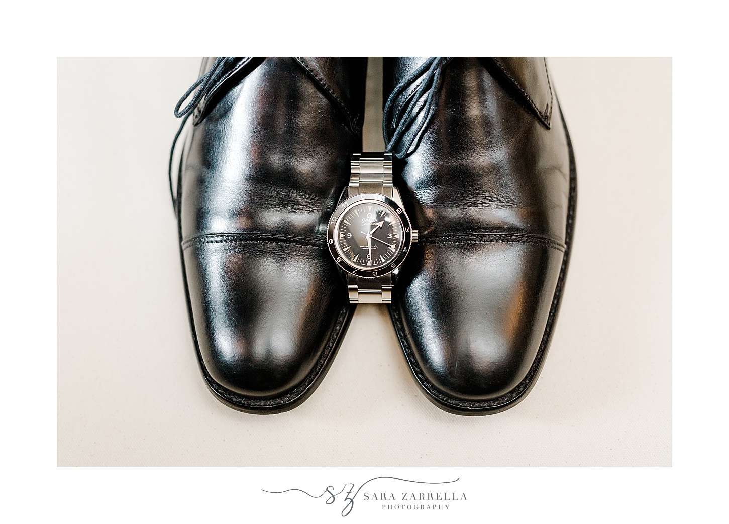 groom's watch rest between black shoes at the Chanler