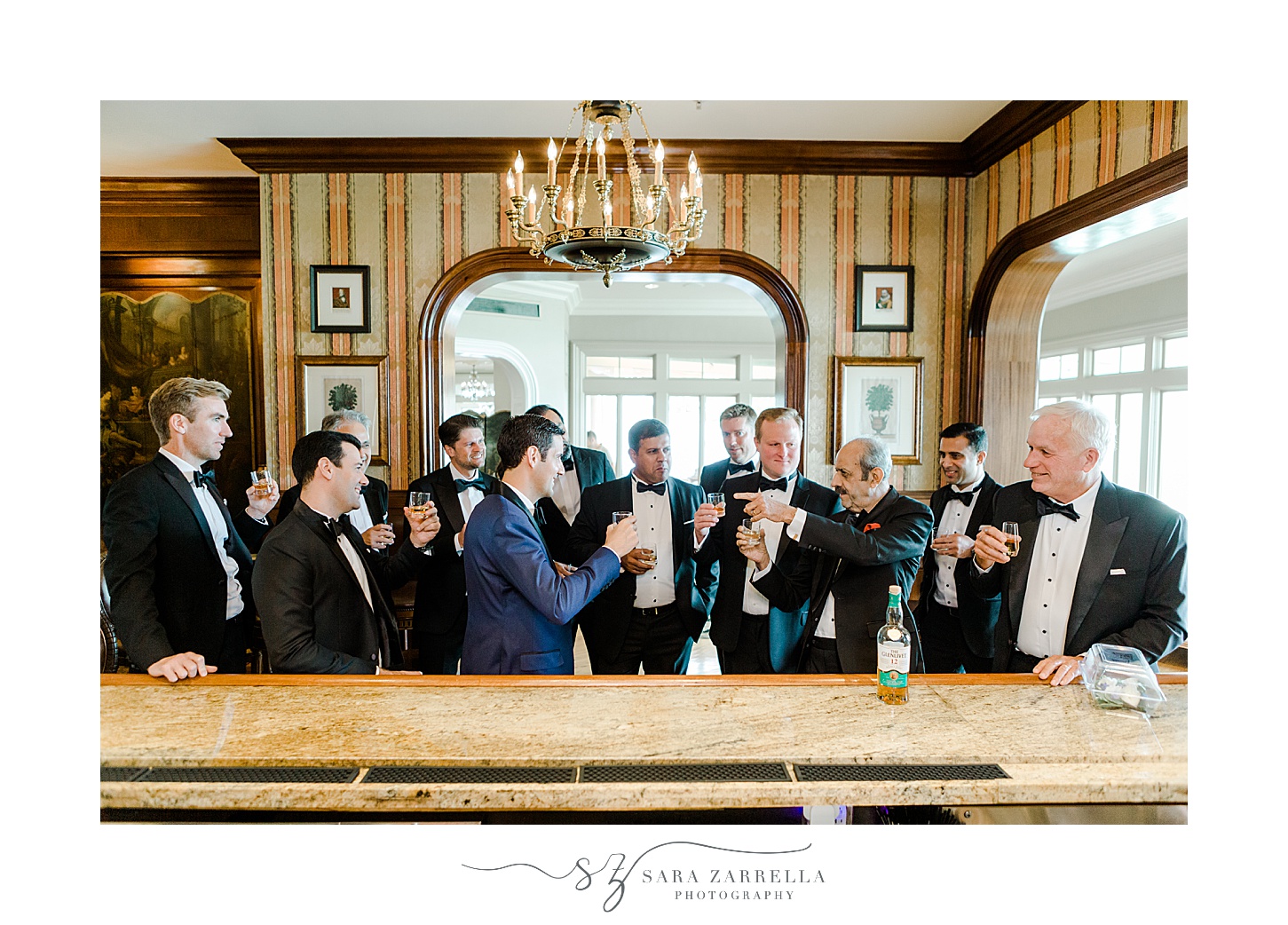 groom and groomsmen have toast at bar inside the Chanler