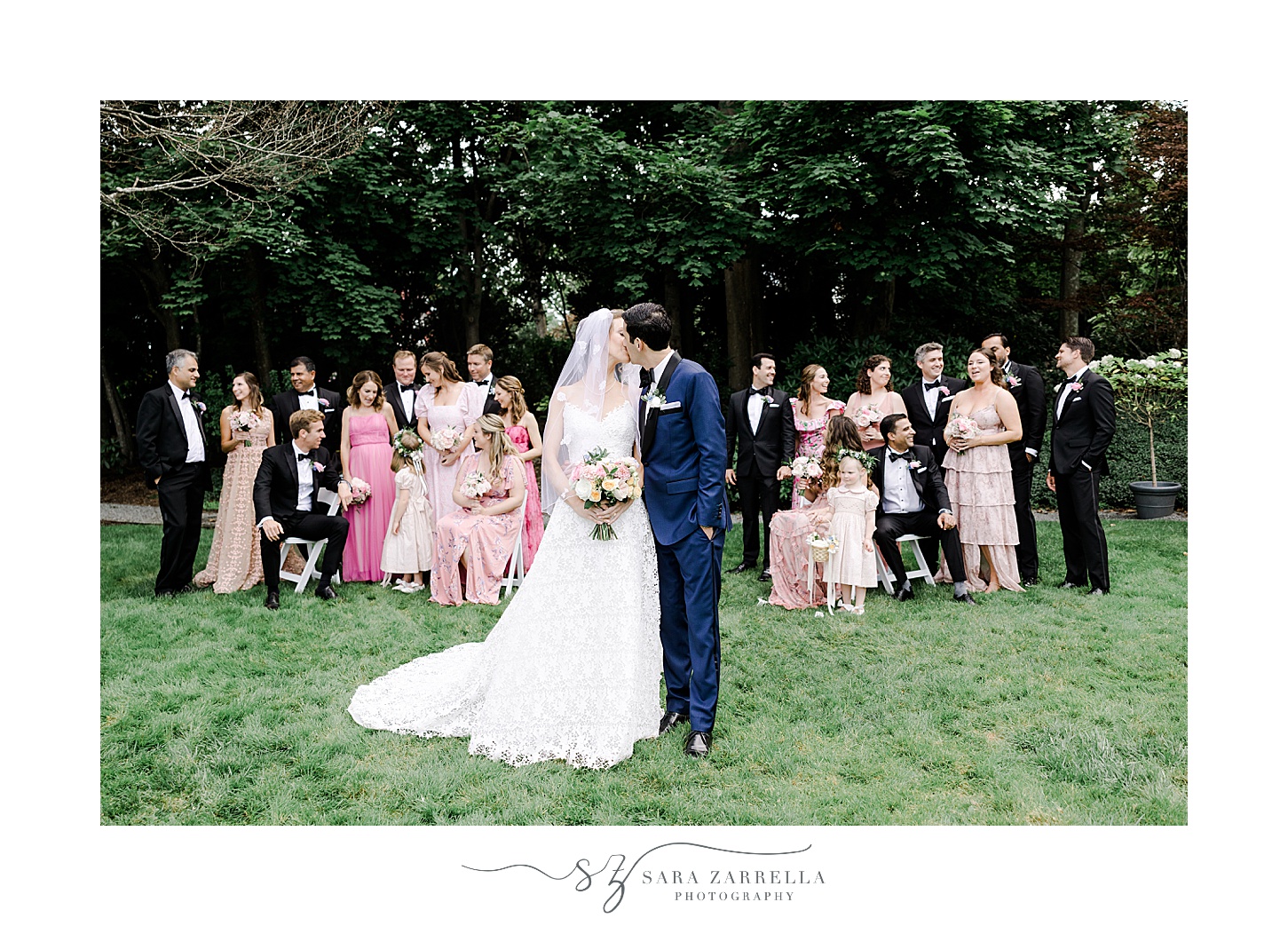 bride and groom pose with wedding party in pink dresses and black suits at the Chanler
