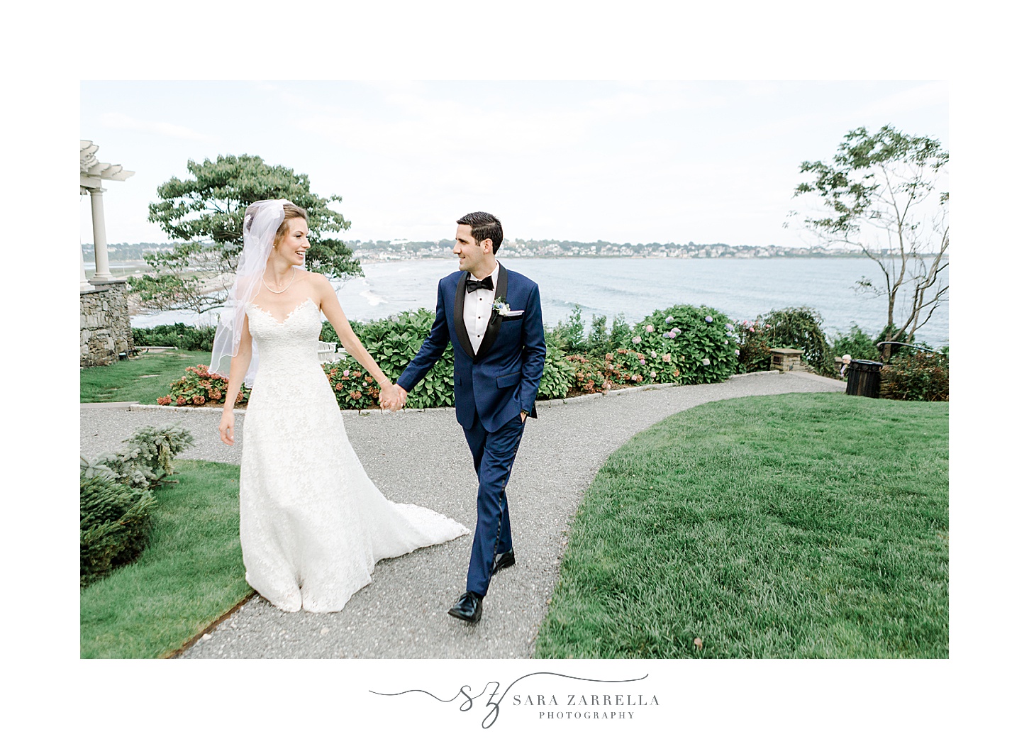 bride and groom hold hands walking on path at the Chanler