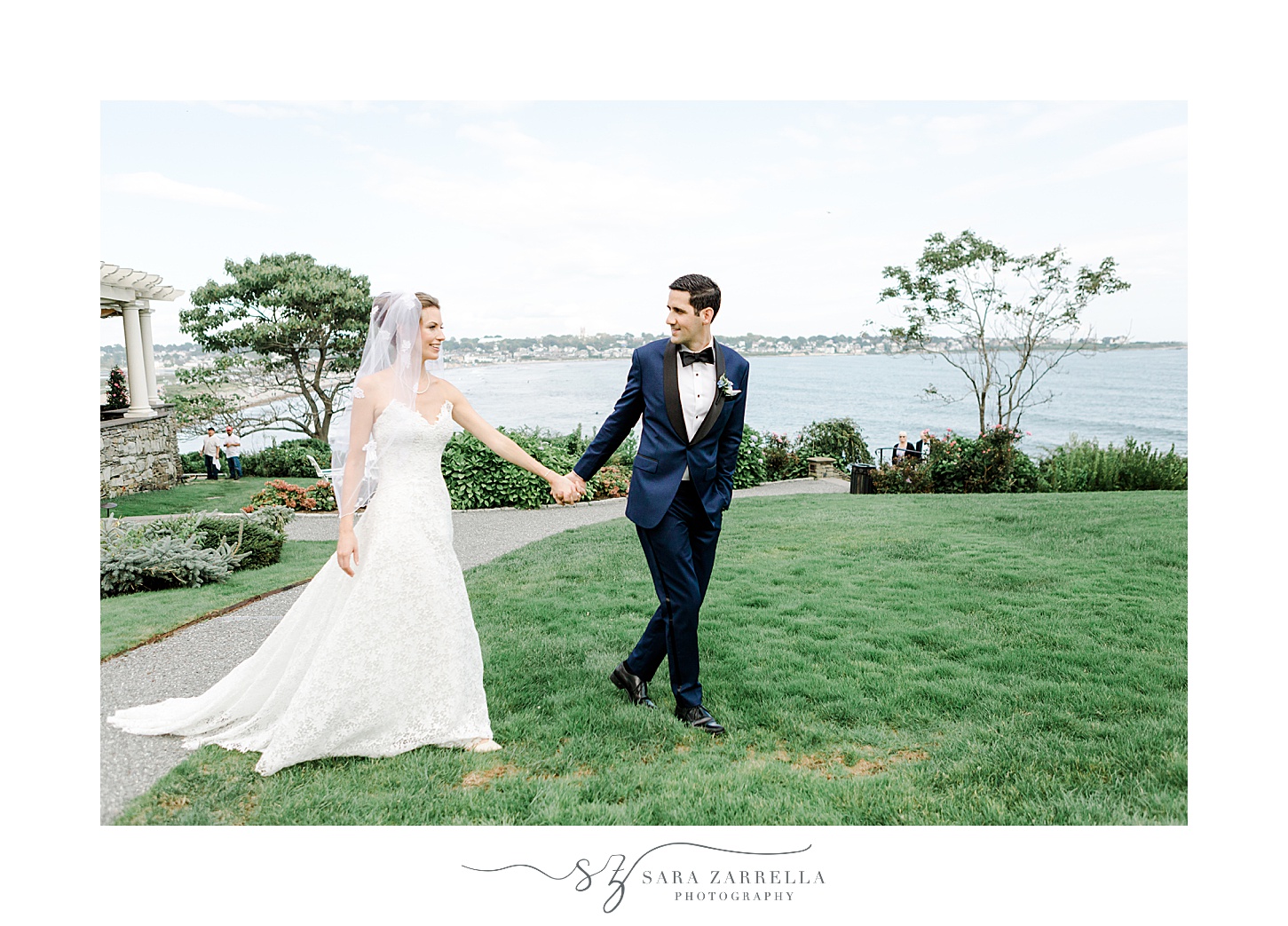 bride and groom hold hands walking on lawn at the Chanler