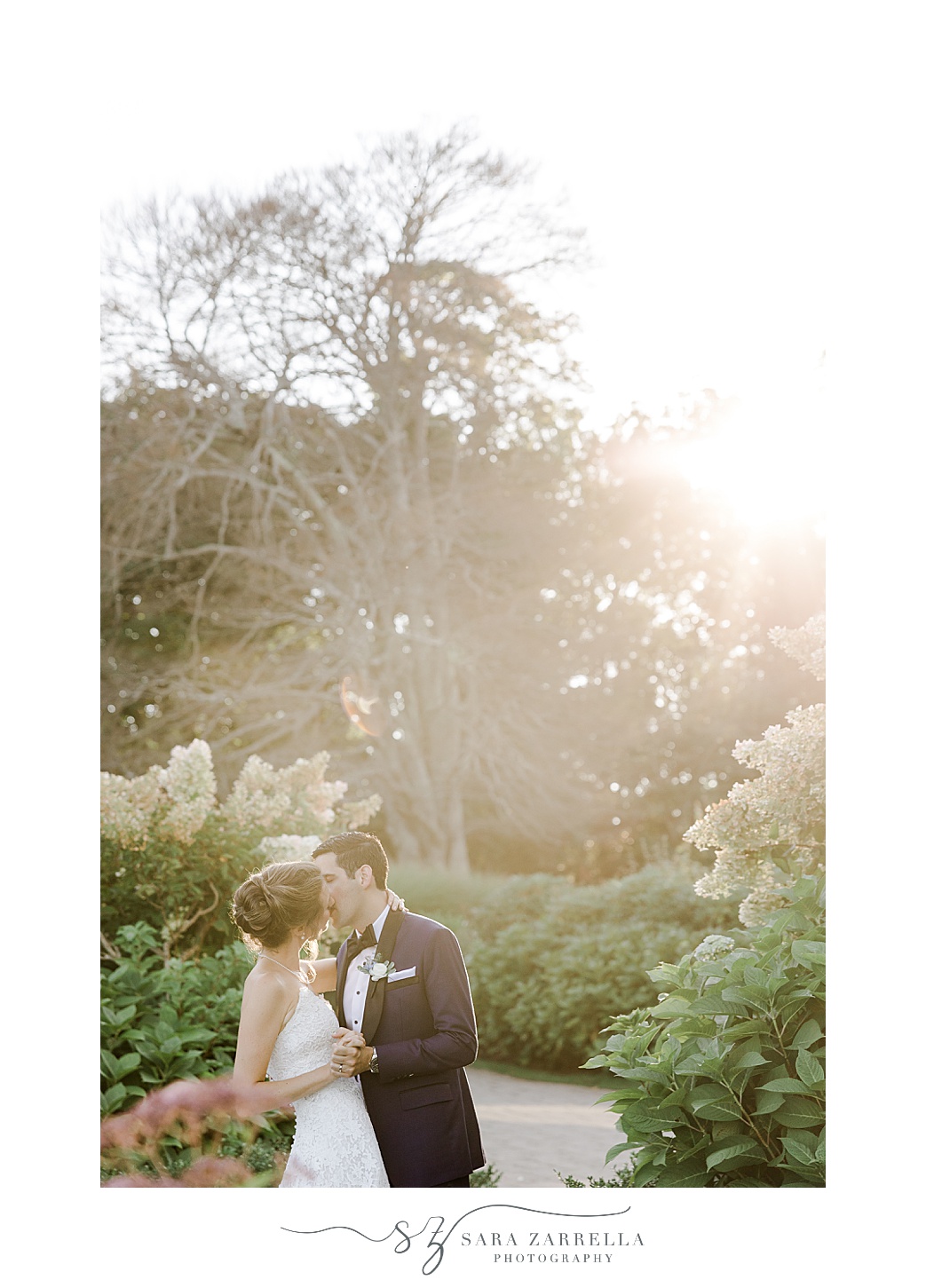 bride and groom kiss at sunset in gardens of the Chanler 