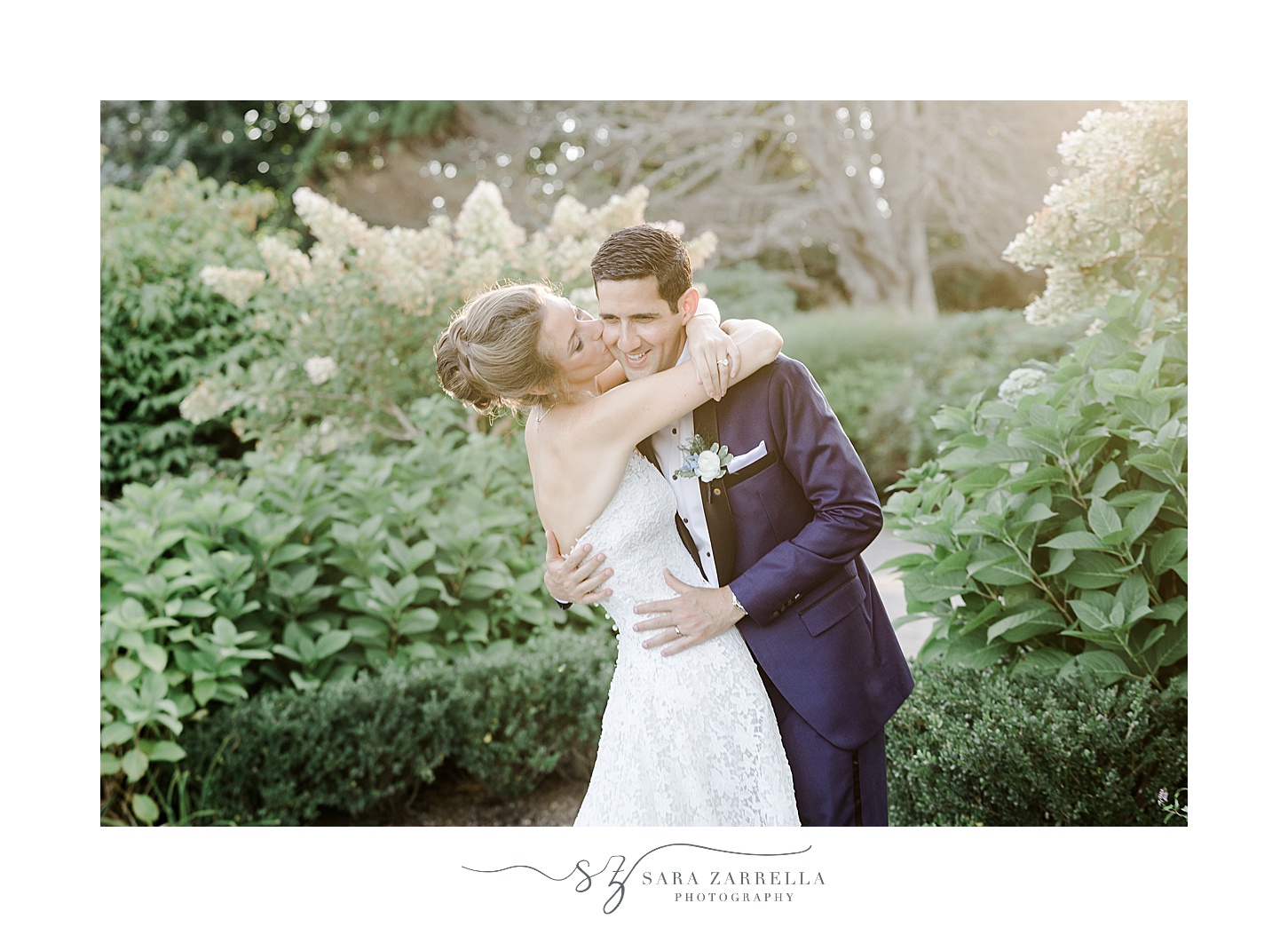 newlyweds hug in gardens of the Chanler 