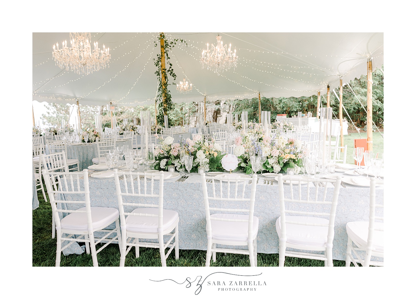 wedding reception seating under tent with blue table cloths 